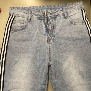 Denim jeans with black stripes down side
